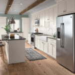 White Shaker Kitchen Cabinets with Island and Built-in Desk - Omni Cabinet Door Style with Snow Finish By Mantra Cabinets